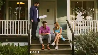 Real estate agent and a young couple reviewing documents on the front porch of a Florida house