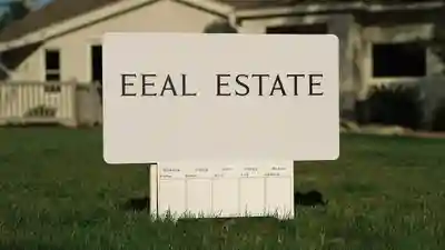 Close-up of a real estate yard sign with a rider panel in a green Florida front lawn