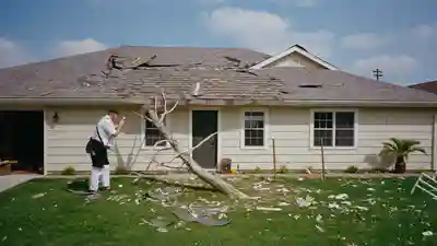 Insurance adjuster photographing missing roof shingles on a Florida house after a storm