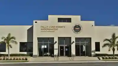 Exterior of a Florida county government administration building with tall palms